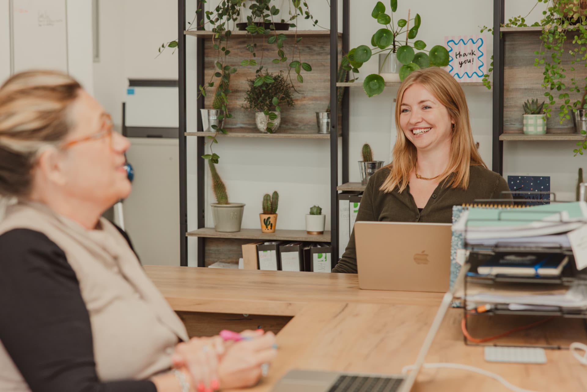 Two members of the Firefly team working at a desk in the Frome office